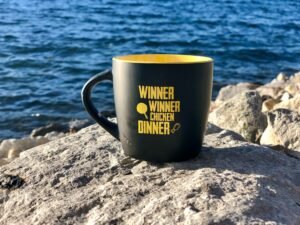 black and yellow mug near body of water